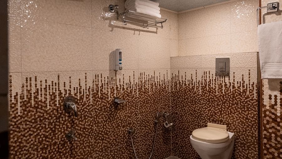 an image of a bathroom with shower and a bucket at Avianna New Mandala Hotel & Spa, Darjeeling