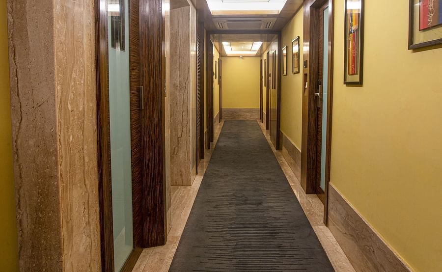 A view of the corridor with rooms accessible on the side, featuring doors that indicate available accommodations.