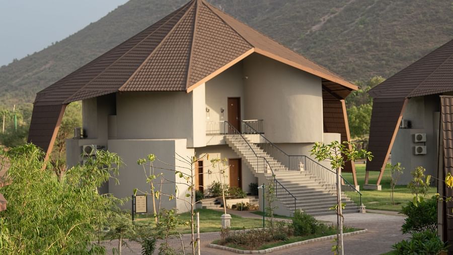 Long view of a villa with the backdrop of majestic mountains at Ananta Spa and Resort, Ajabgarh