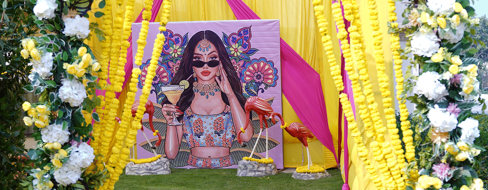 Brij Eternity, Vrindava |   A floral archway with yellow accents welcoming guests to the wedding venue.