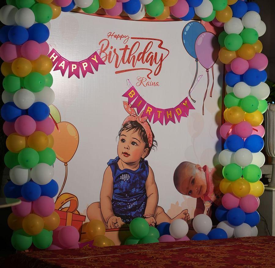 The stage at Rangamati Garden Resort showcases a photo of a baby girl, complemented by a balloon garland on the side.