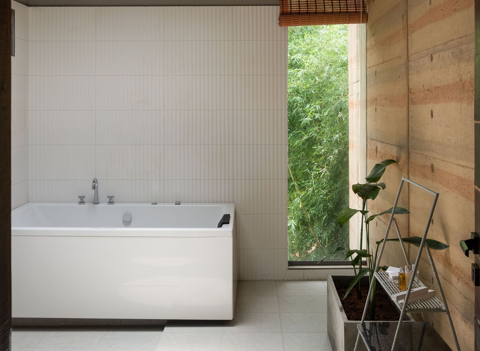 A modern bathroom or utility space with a white countertop, a circular light fixture on the ceiling, and minimalist design | Gaia Studio | RD's Nature Retreat, Bangalore