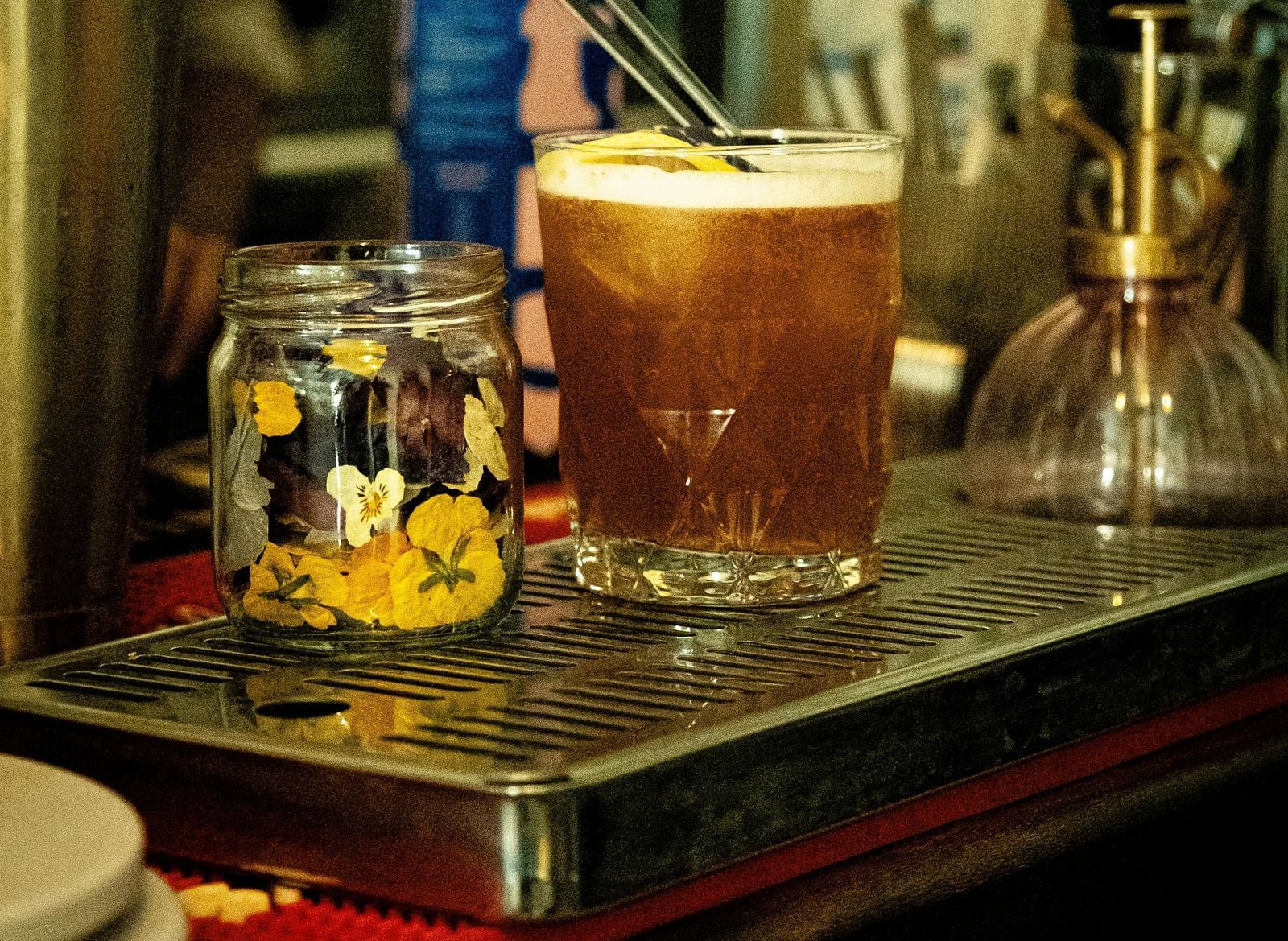Bartender mixing a drink, showcasing the intricate preparation of a drink.