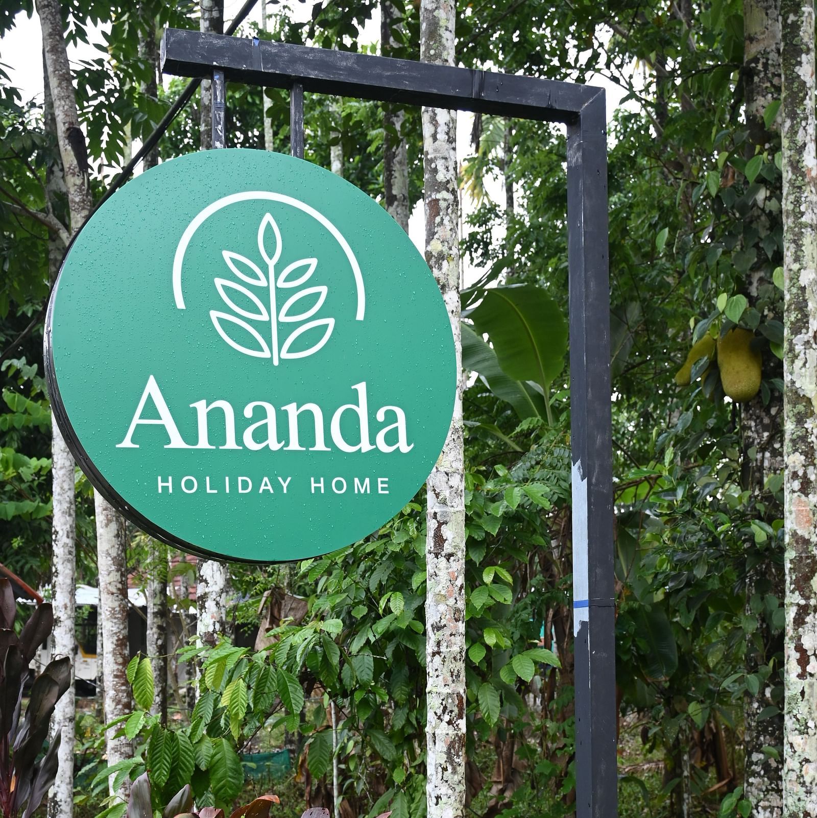 A signboard of Ananda Holiday Home, Wayanad