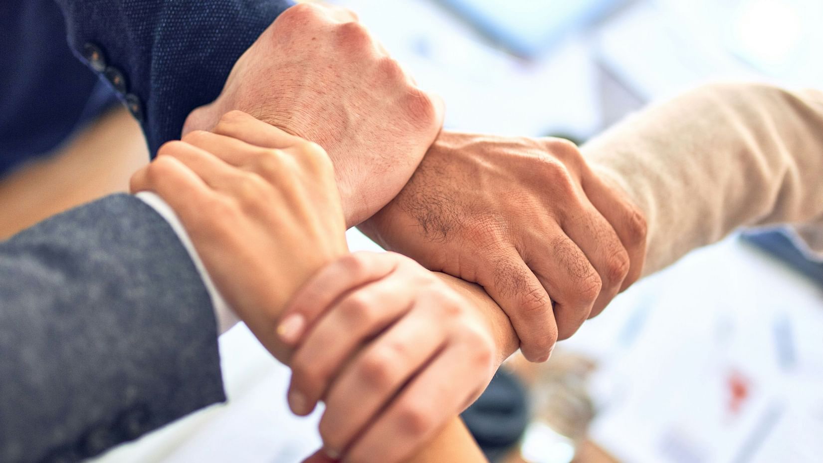 Team members shaking hands in a professional office setting