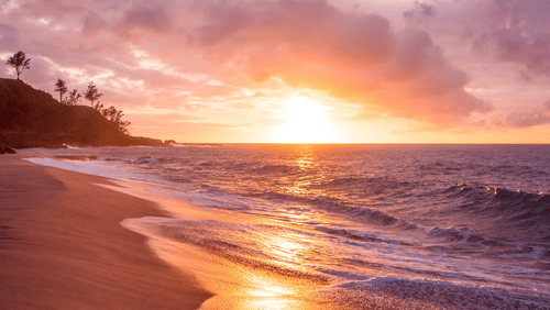 A picturesque view of the tide sweeping the shore during sunset - beach-facing hotels in Mumbai