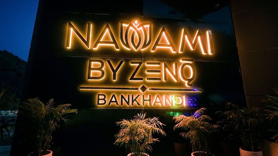 A signage of our hotel name illuminated by warm coloured light - NAMAMI BY ZENQ BANKHANDI
