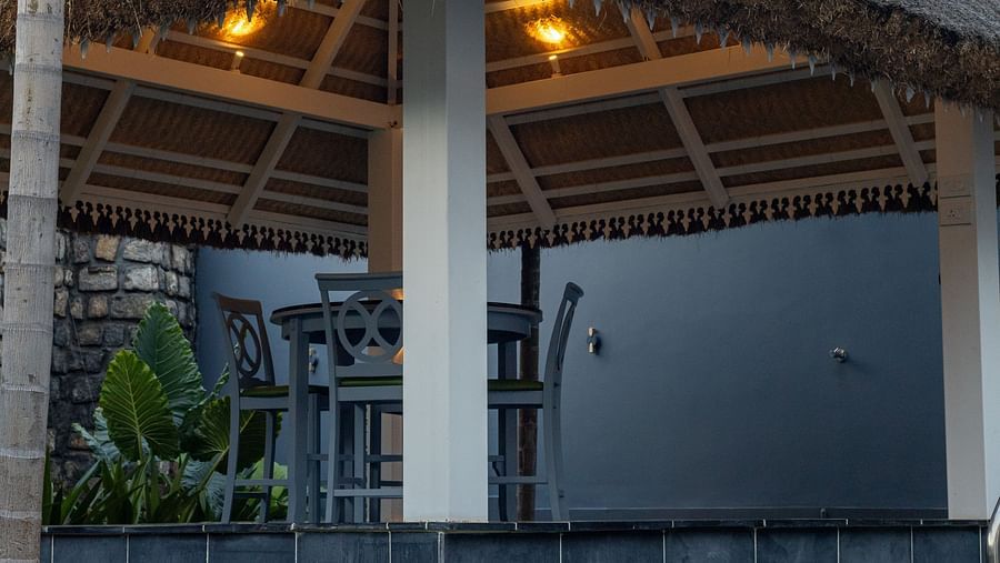 image taken from a lower angle featuring the swimming pool and the outdoor seating area under the gazebo at the Grand Pool Villa - Darza Resorts