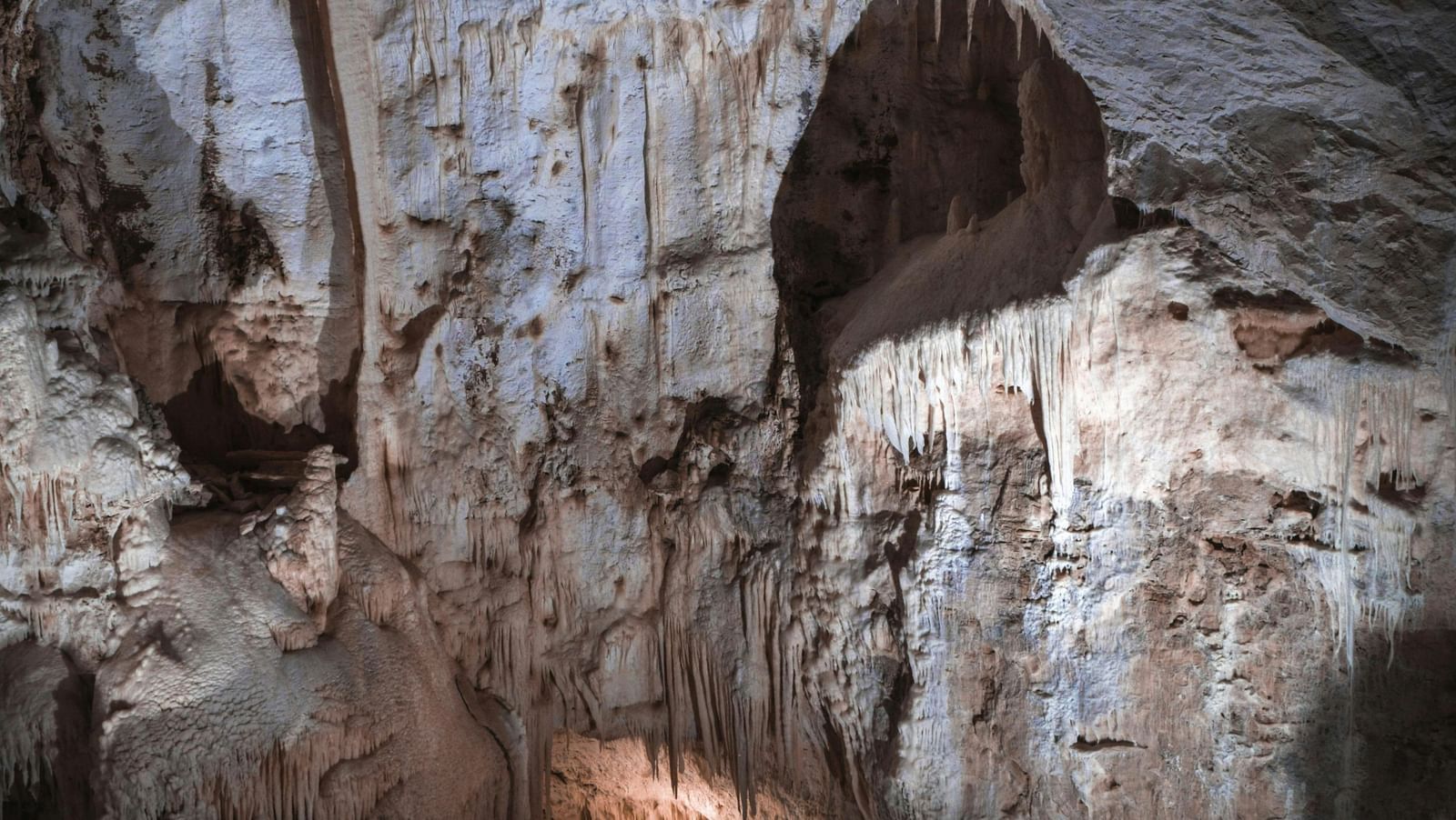 Interior of a cave featuring Stalagmite formations in a limestone cave.