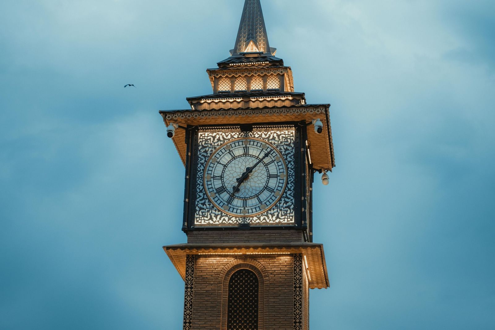 Clock tower against a blue sky in a traditional architectural style.