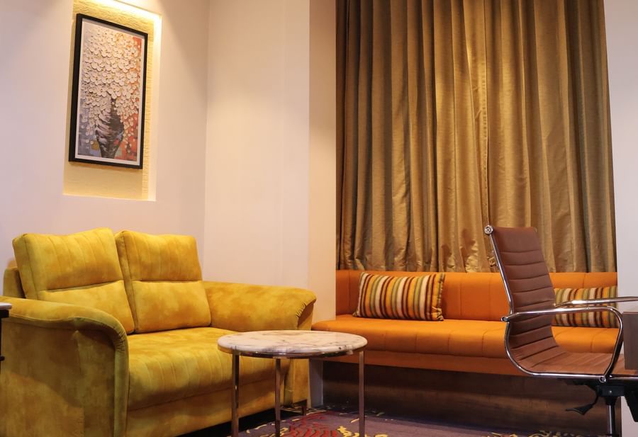 Lounge area with yellow armchairs and sophisticated lighting at Best Western, Vrindavan.