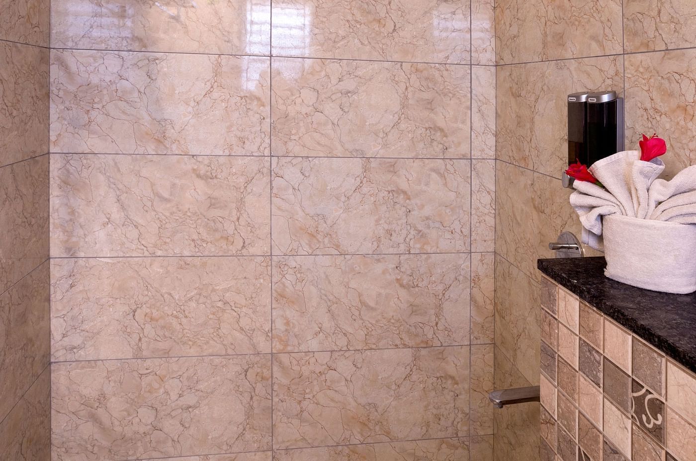 Clean bathroom with walk-in shower and tiled walls – Nirantara Resort & Spa
