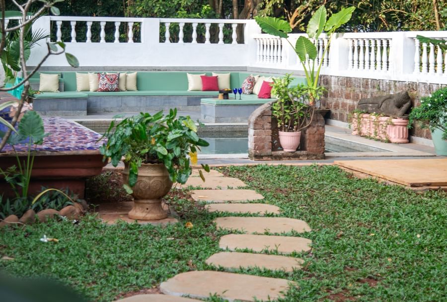 Stone path way in a green lawn @ Lamrin Ucassaim Hotel, Goa