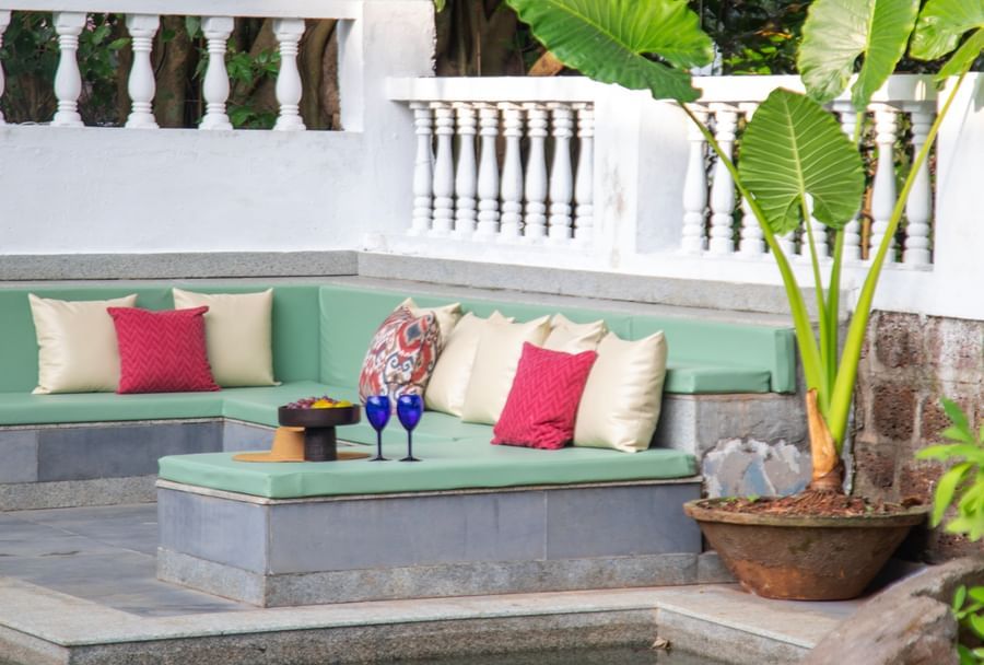 Pool with green trees surounding it @ Lamrin Ucassaim Hotel, Goa