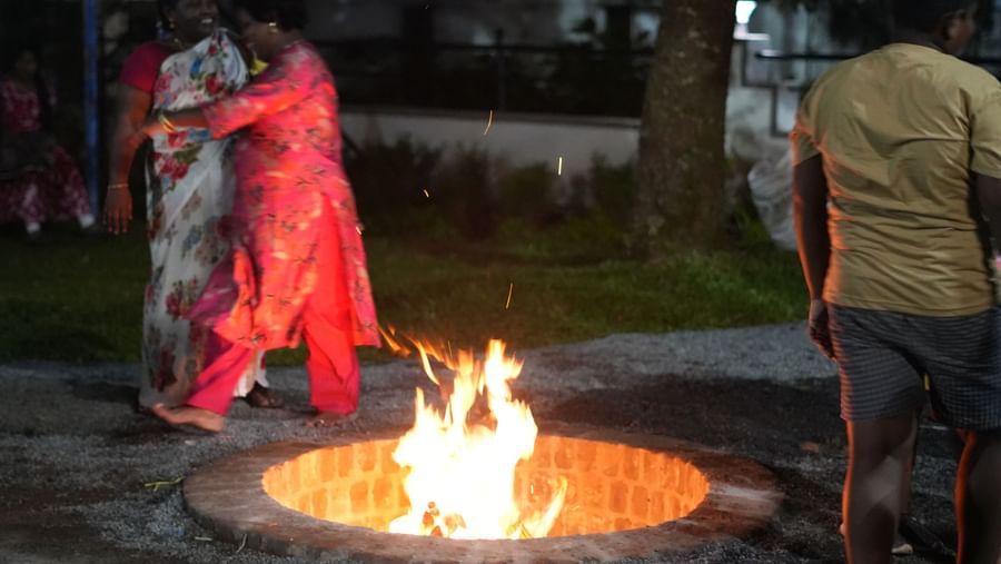 An outdoor bonfire at WOW Naturefull Resorts during a late evening with people enjoying it.