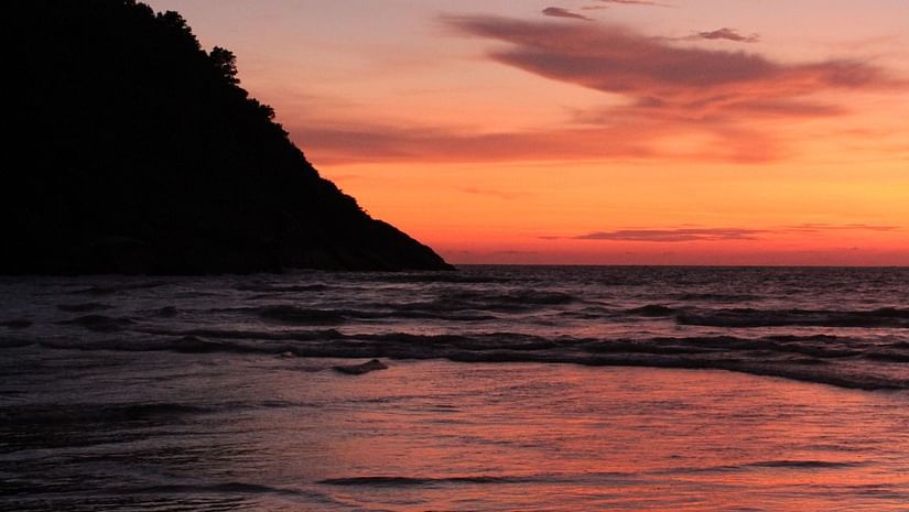 A serene sunset seen from the side of a hill