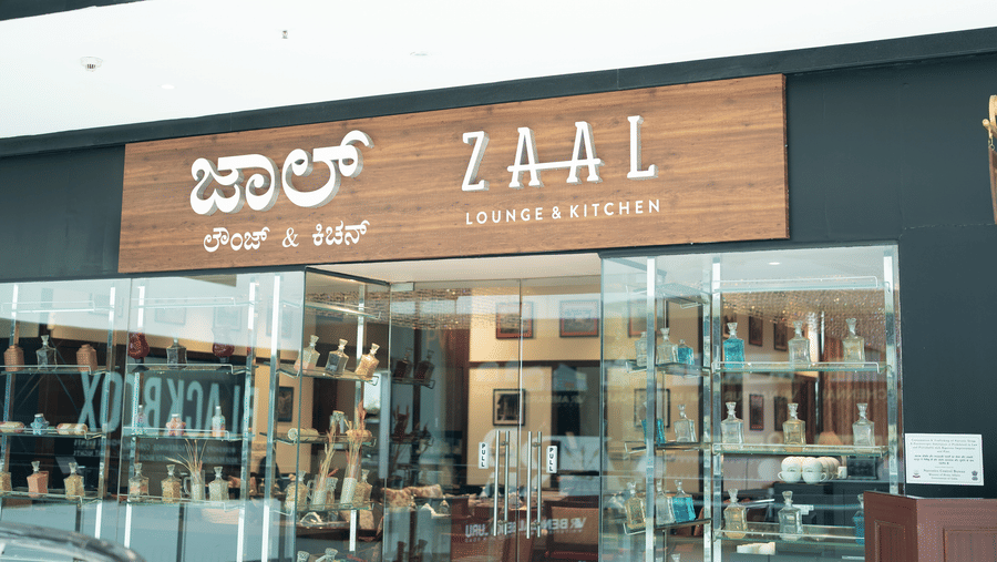 Zaal Lounge & Kitchen entrance with Kannada and English signage at The Waverly Hotel & Residences, Whitefield