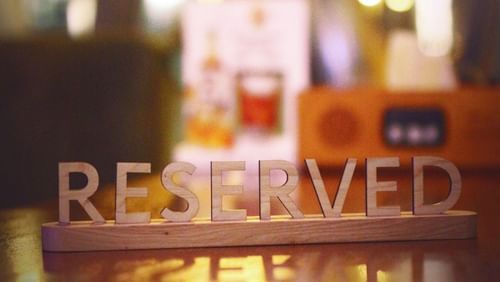 a board with the word reserved written on it kept on a table 