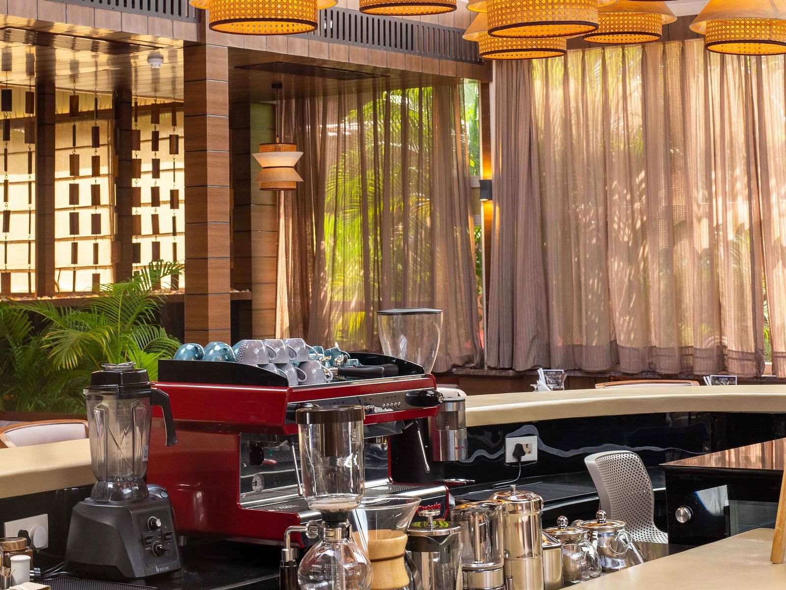 5th Bistro Cafe and Bar featuring a stylish bar area with contemporary lighting fixtures and modern furniture. The space is well-lit, creating an inviting environment for guests to relax and socialise - Coral Reef Resort & Spa, Havelock