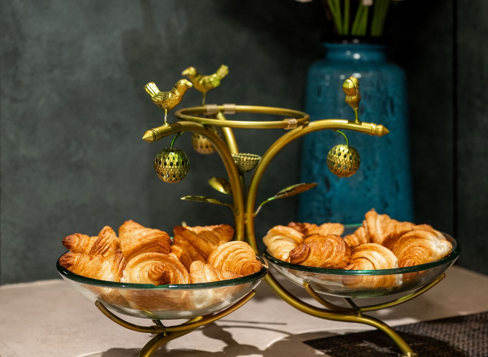 Flower arrangement with croissant displayed on a stand at Hotel Royal Regency Chennai
