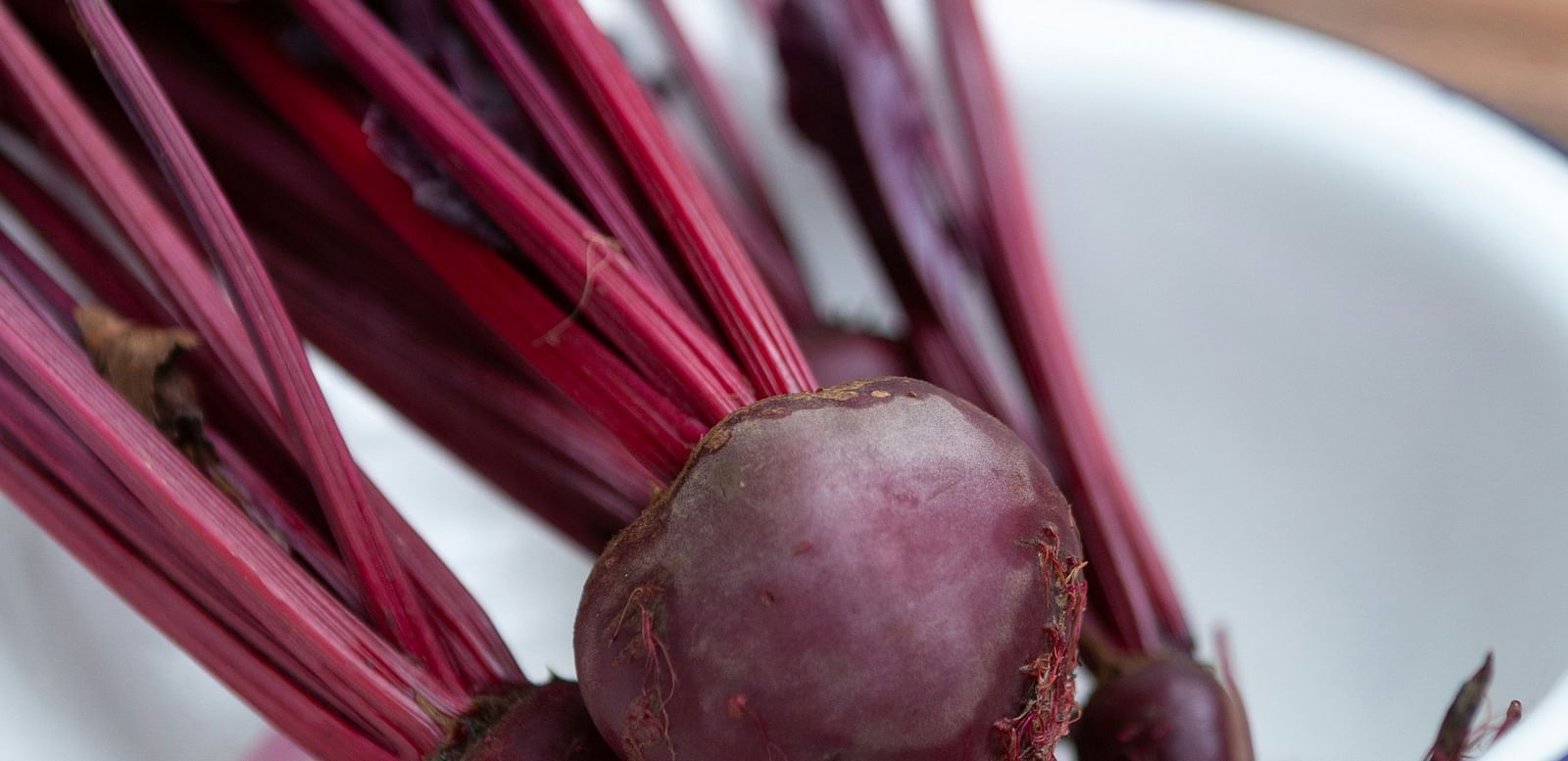 Multiple beetroots placed in a bowl.