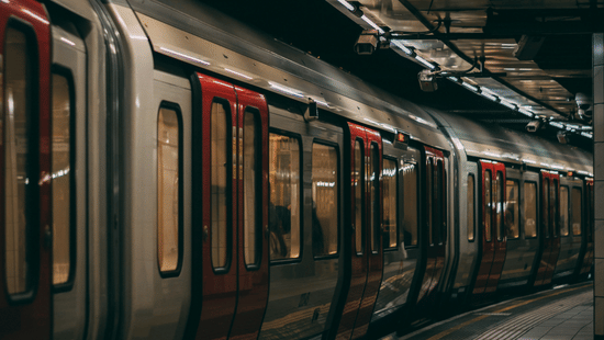 Atmospheric nighttime view of a train platform with warm lighting .