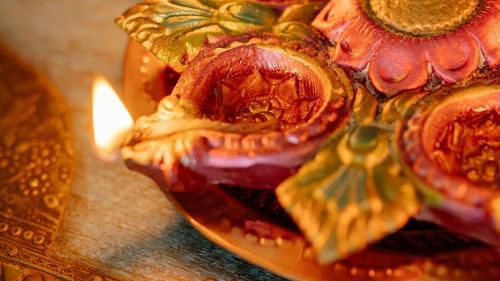  A clay lamp has been lit using cotton and oil.