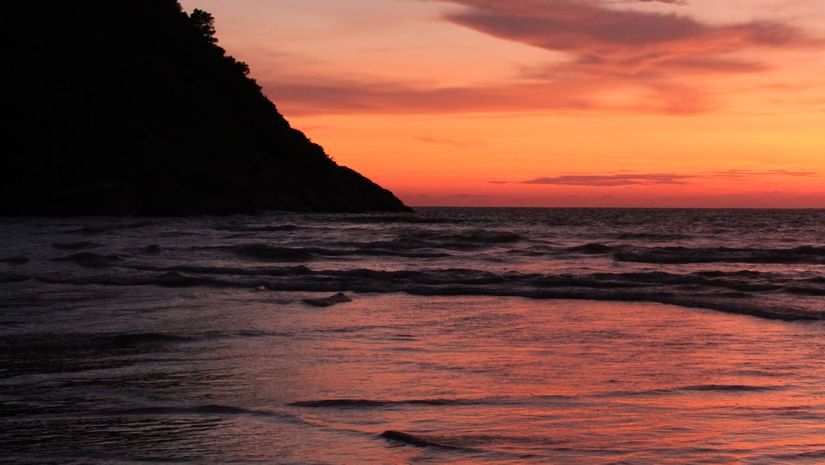 A serene sunset seen from the side of a hill