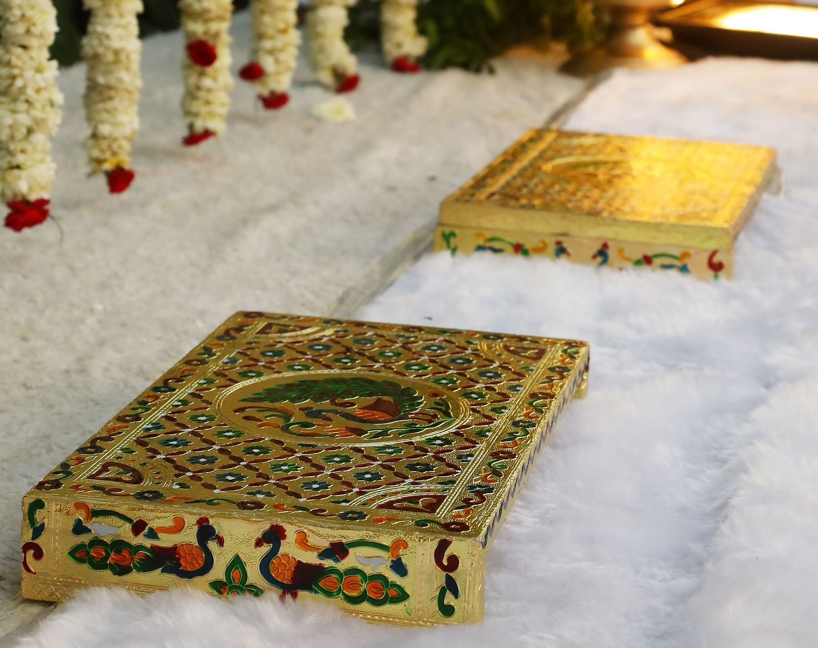 Floral garlands and rugs placed at an entry or ceremonial area at Tisya Farms, Gurgaon.