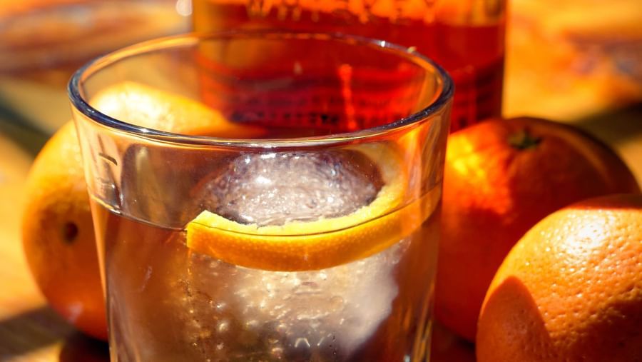 Bulleit bourbon whiskey served with a large ice cube on a wooden bar at Narrow Gauge Inn.