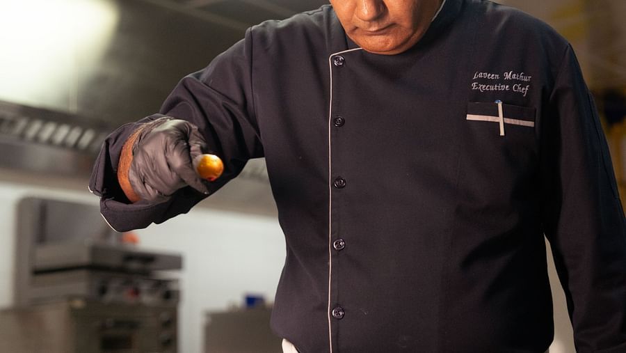 A chef working in a kitchen at Ananta Spa and Resort, Ajabgarh