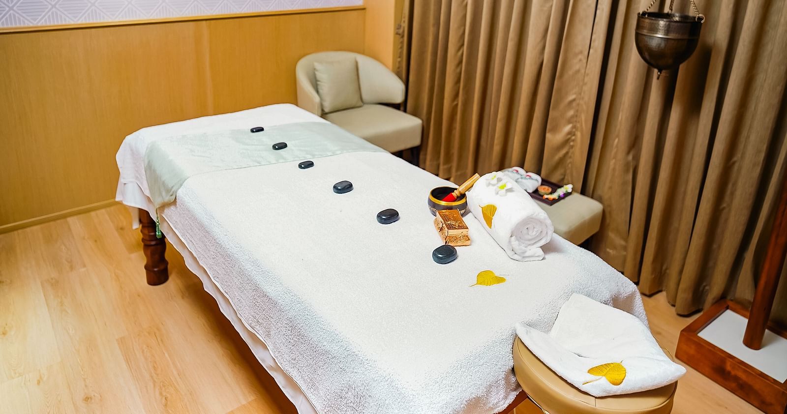  A serene Bodhi Spa treatment room with a massage table, neatly arranged for relaxation