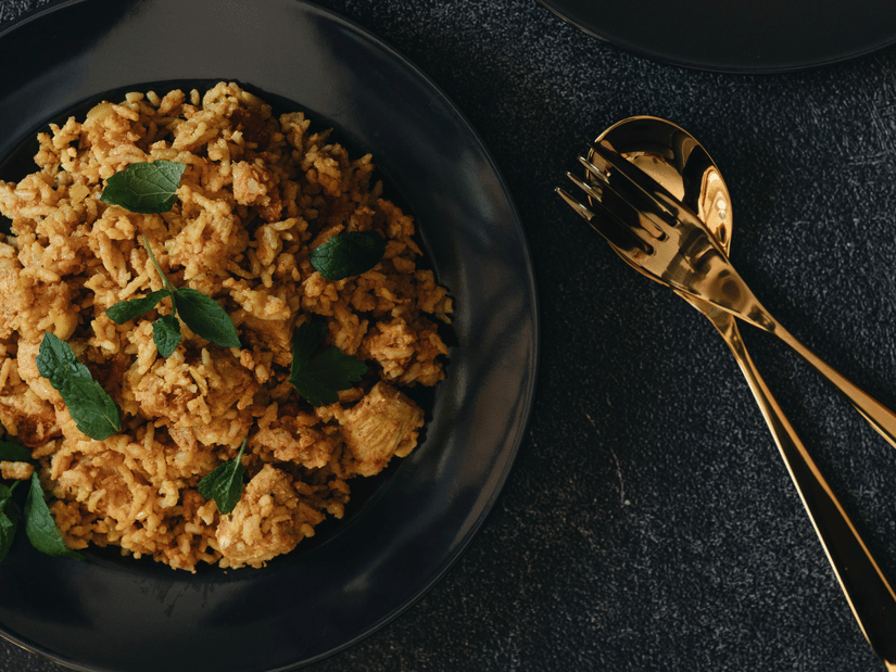 2 bowls of spiced Chettinad-style dry curry placed on a dark surface, showcasing coarse texture, herbs, and traditional South Indian preparation