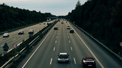 An overview of a 6-lane highway with cars travelling on both directions and trees on either side of the road, as seen during the Pune to Goa trip by road.