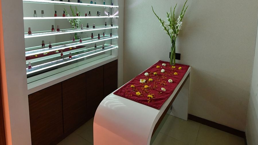 many nail polish bottles kept in a showcase for customers to select - IOSIS Spa & Wellness