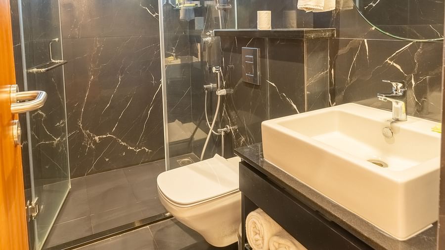 image of a bathroom at the luxury group stay villa with a shower cubical and a full appointed vanity area - Darza Resorts