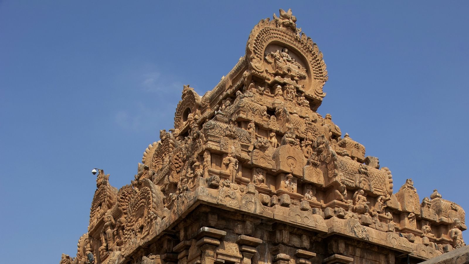 Ancient stone temple with intricate carvings and weathered architecture.