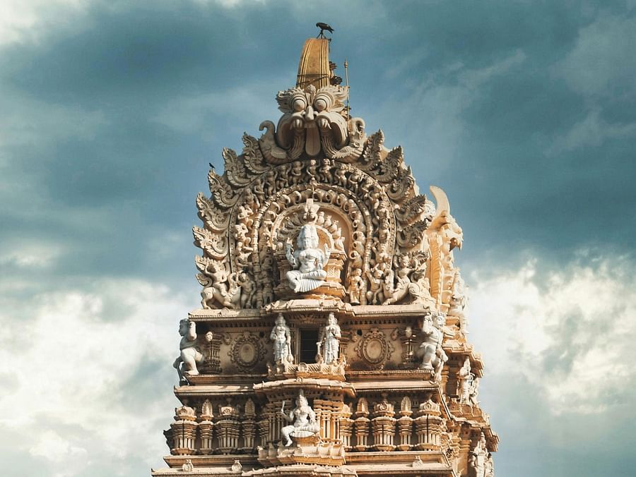 A tall, intricately carved gopuram of the famous Chamundeshwari Temple.