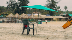 a chair under a beach umbrella