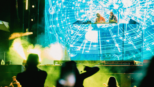 People at a concert that is well lit.