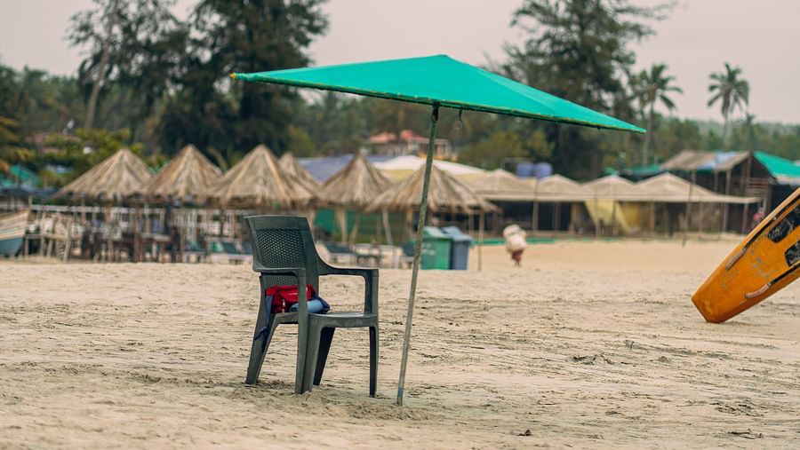 a chair under a beach umbrella