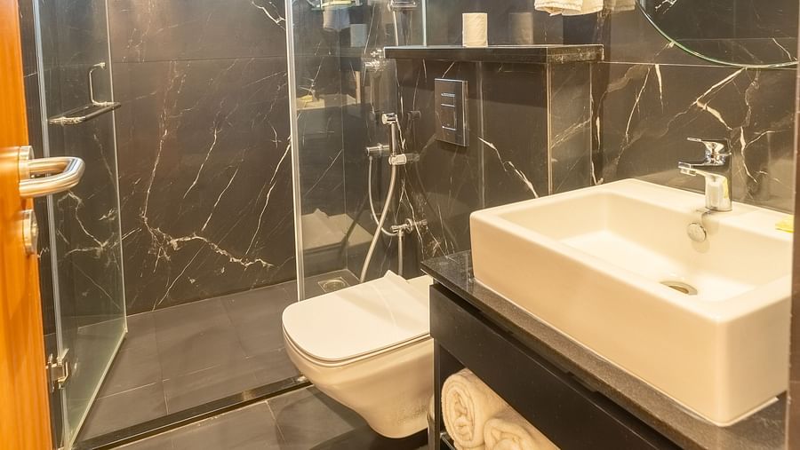 image of a bathroom at the luxury group stay villa with a shower cubical and a full appointed vanity area - Darza Resorts