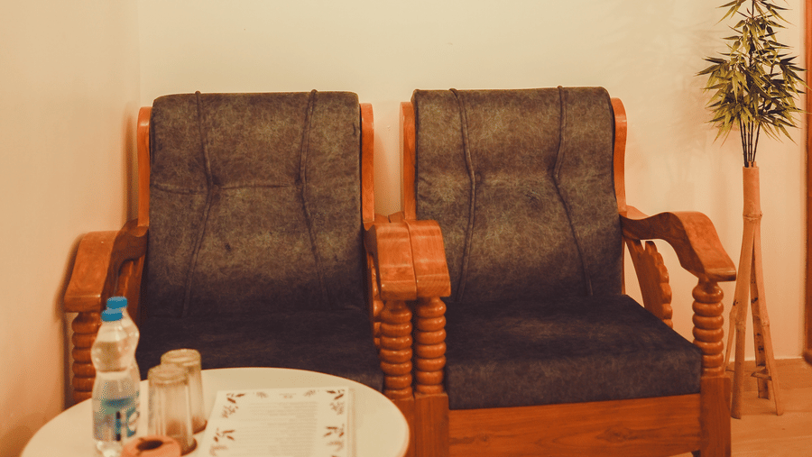 The common seating area with 2 cushioned chairs with a round coffee table in front of it | Dip Holidays