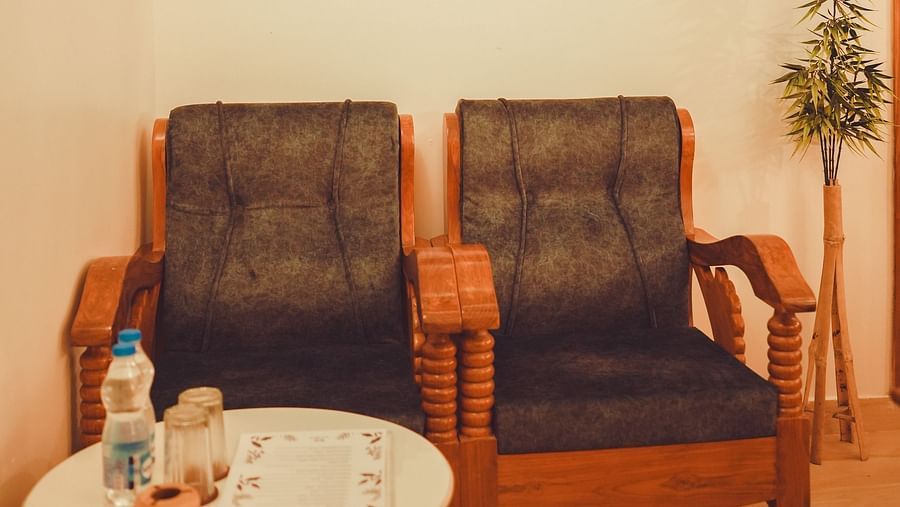 image of the common seating area with two cushioned chairs with a round coffee table in front of it