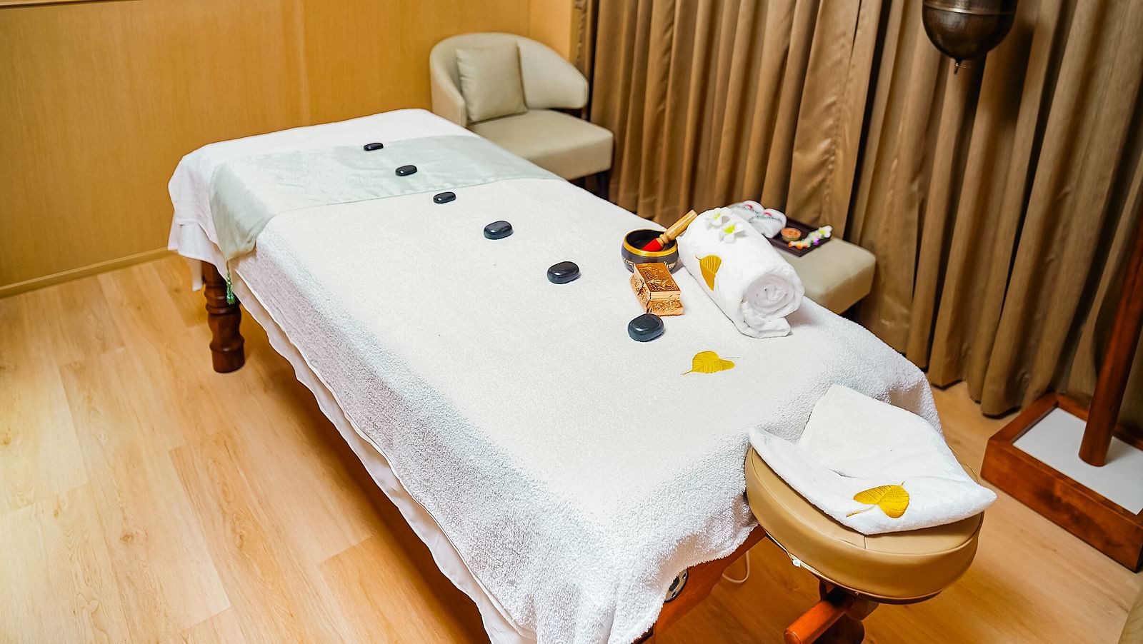  A serene Bodhi Spa treatment room with a massage table, neatly arranged for relaxation - Grand Madurai by GRT Hotels