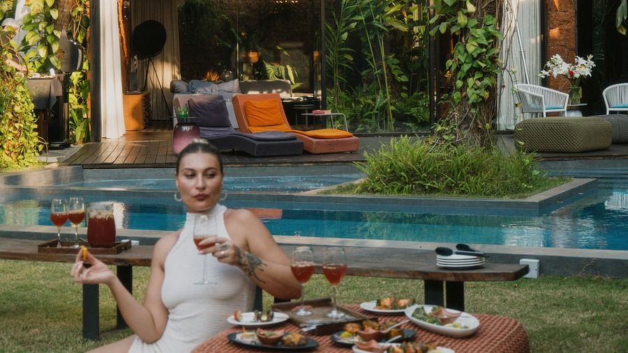 A woman enjoying a refreshing swim in a luxurious pool.