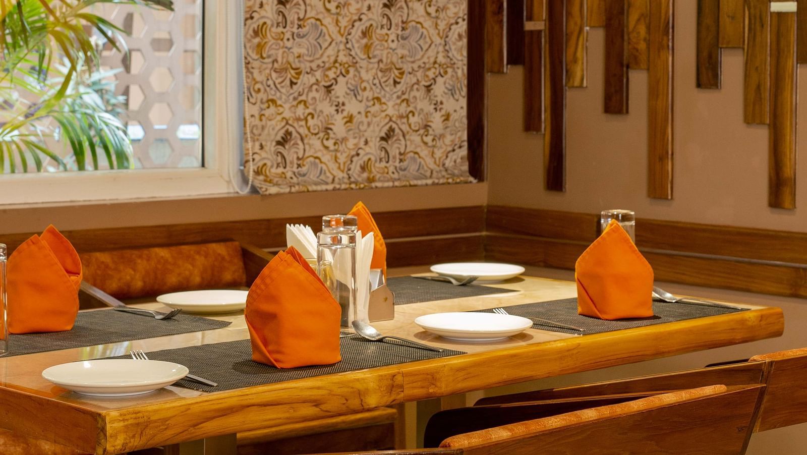 Image of table arranged with cutlery and napkins at Honeycomb Restaurant at Coral Reef Hotel & Spa in Port Blair