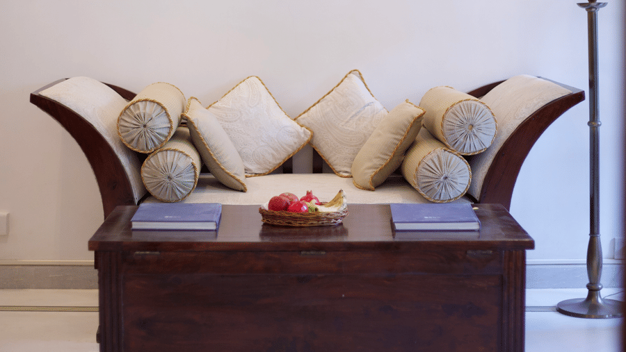 Inviting seating nook with cushioned bench and tasteful décor in a heritage suite at Shahpura Bagh.