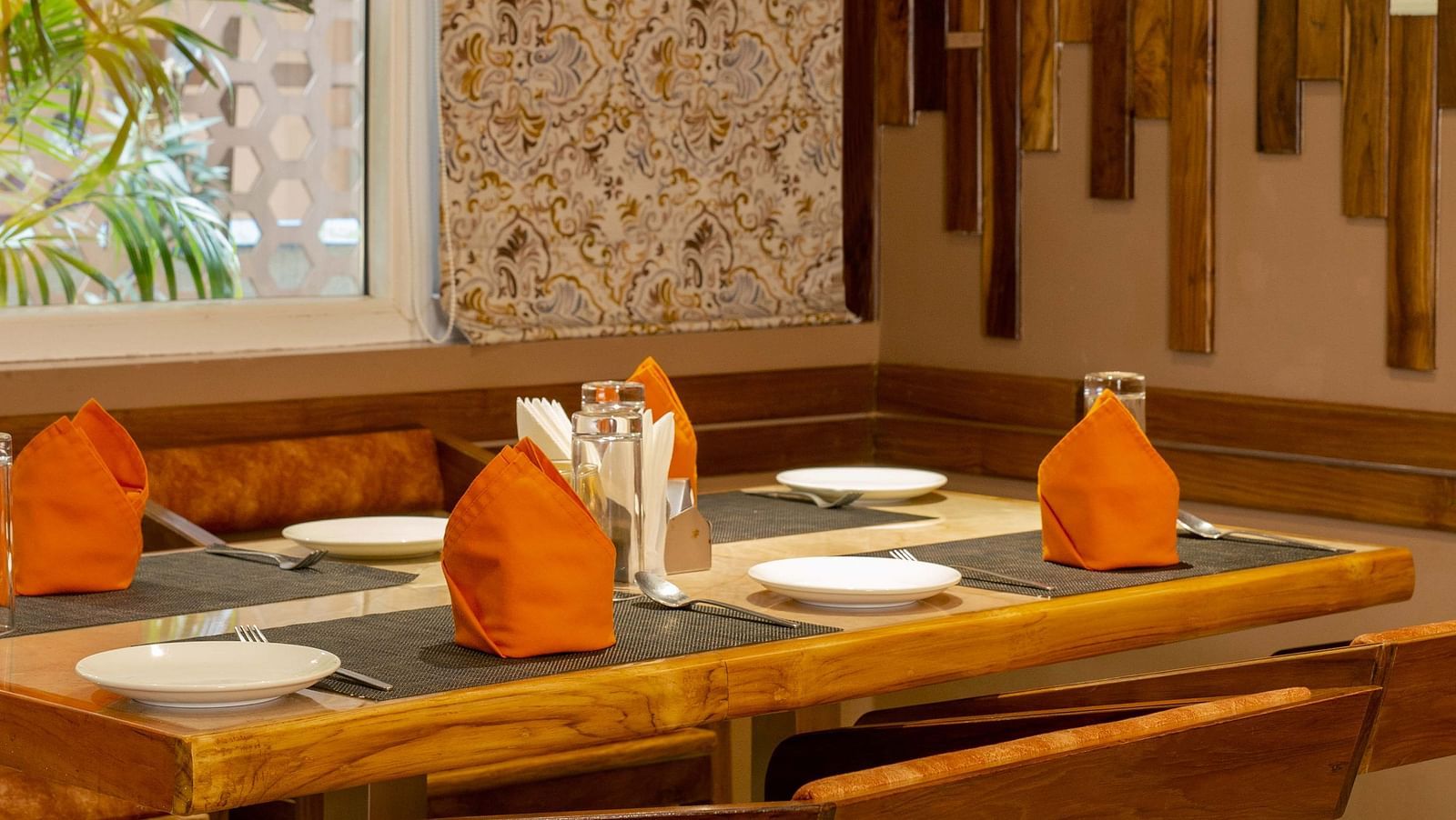 Image of table arranged with cutlery and napkins at Honeycomb Restaurant at Coral Reef Hotel & Spa in Port Blair