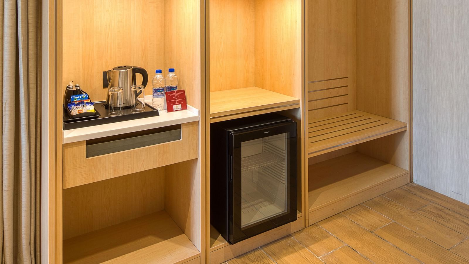A cupboard at Executive Room at Le Foliage with a minibar and a tea and a coffee maker